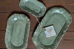 Tre gröna fat med knipt kant.